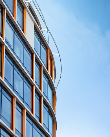 Low Angle Photography of Orange and White Glass-curtain Building