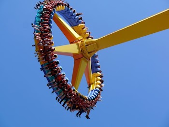 low-angle photography of people on yellow playground equipment