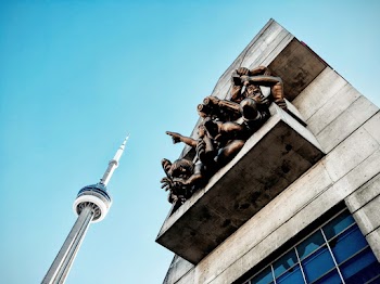 Low angle photography of statues on a wall 