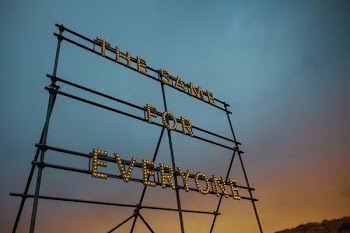 low angle photography of the same for everyone LED signage on tower under gray sky