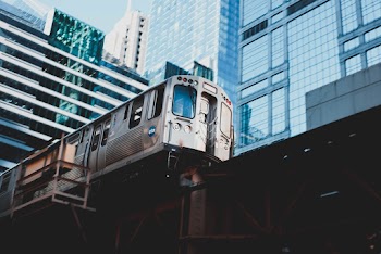 Low Angle Photography Of Train Near Buildings