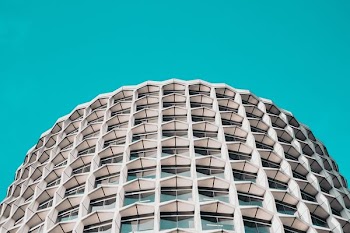 low-angle photography of white concrete high-rise building