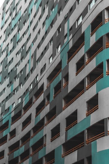 Low Angle Photography of White-green-and-gray Concrete High-rise Building