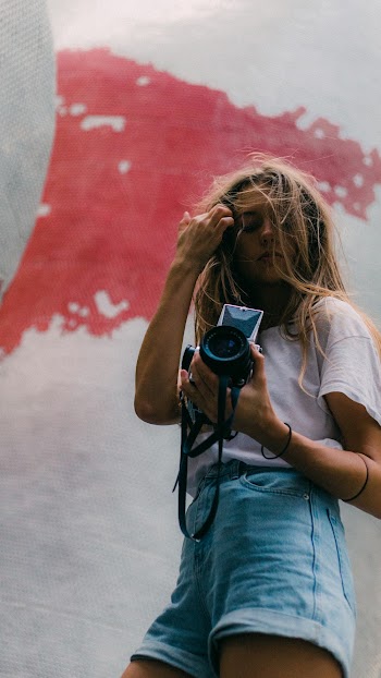 Low-angle Photography of Woman Carrying a Dslr Camera