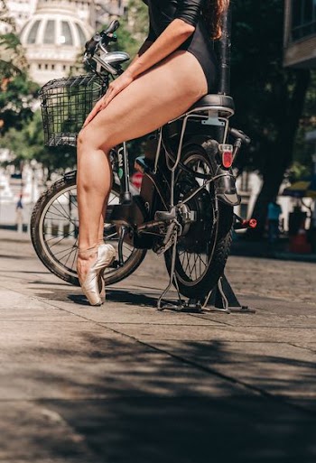low angle photography of woman driving city bike