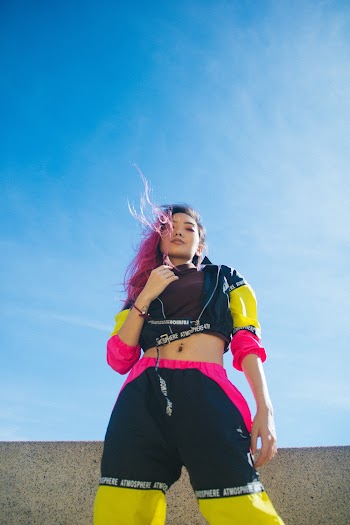 Low-angle Photography of Woman Standing Under Calm Blue Sky