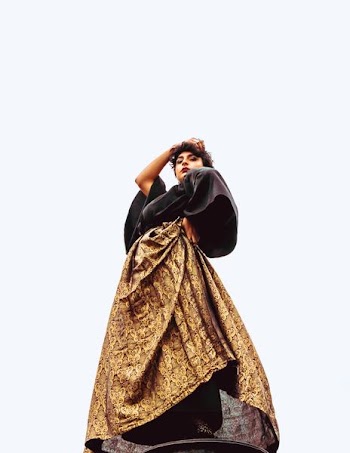 low-angle photography of woman standing wearing brown and black maxi dress