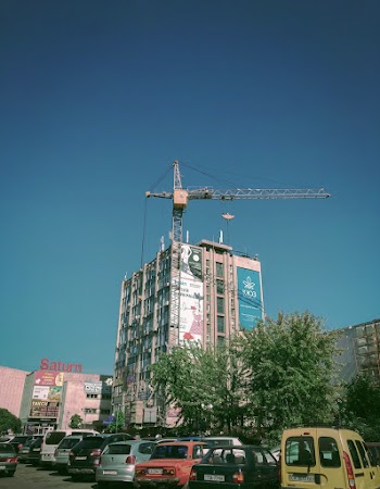 Low Angle Shot Of A Building With A Crane On The Rooftop