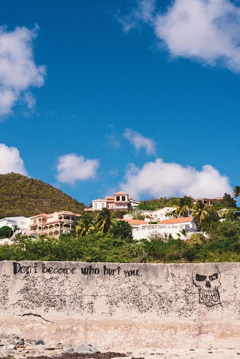 Low Angle Shot Of A Concrete Wall With Graffiti Close To Buildings In The Hills 