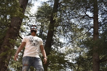 Low angle shot of a man wearing a white crew-neck t-shirt