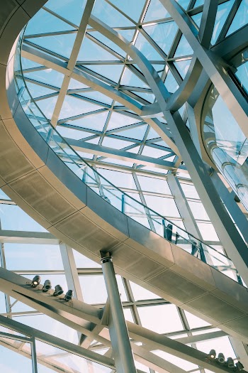 Low Angle Shot Of A Modern Building Design Of Steel And Glass Panels