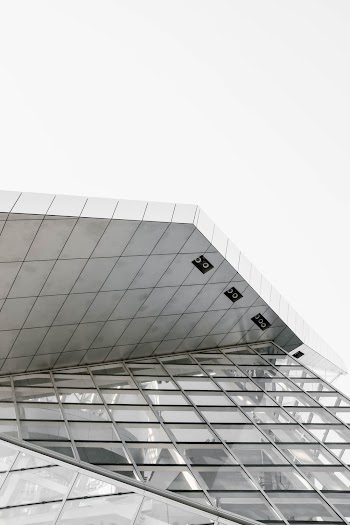 Low Angle Shot Of A Modern Glass Building In Black And White