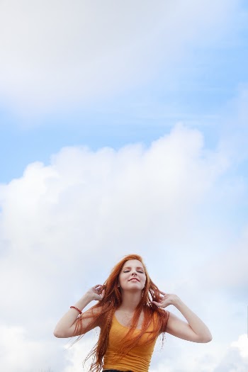 Low Angle Shot Of A Woman With Long Red Hair in Orange Scoop-neck Tank Top 