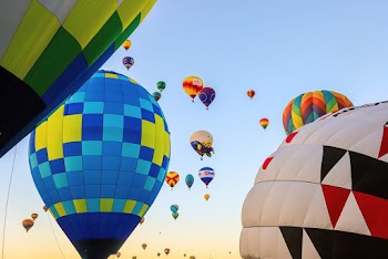 Low Angle Shot Of Airborne Multi-Colored  Hot Air Balloons