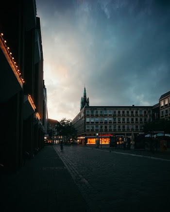 Low Angle Shot Of City Buildings On An Empty Street Under Cloudy Skies At Dusk