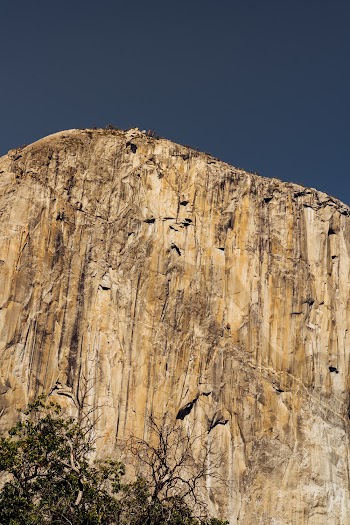 Low Angle Shot Of Rocky Mountain Cliff Under Blue Sky