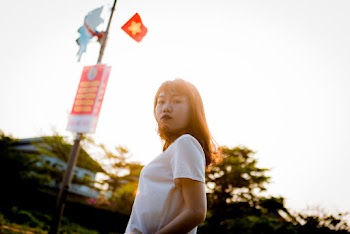 Low Angle Shot of Standing Woman in White T-shirt Posing