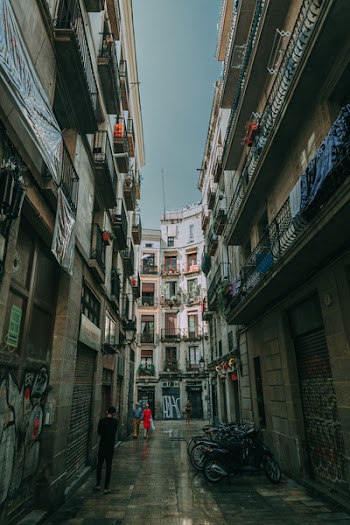 Low Angle Shot of Two People Walking on Alley