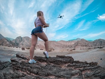 Low Angle Shot of Woman Flying a Drone