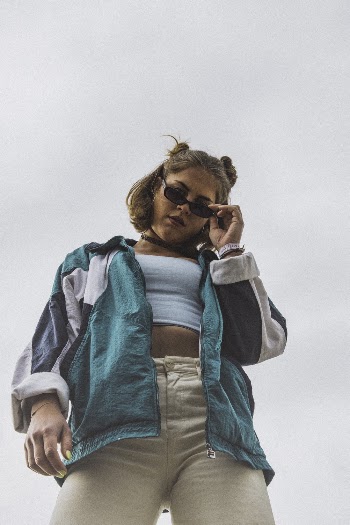 Low Angle Shot of Woman in Black Sunglasses Looking Down