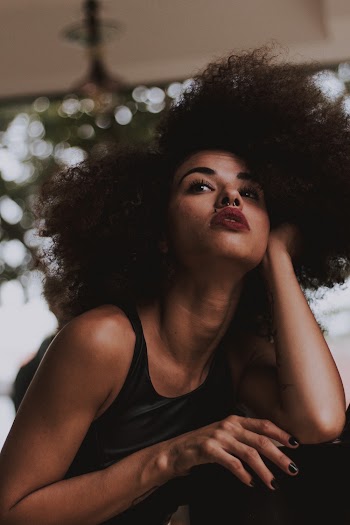 Low Angle Shot of Woman Posing While Holding Her Hair