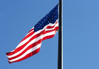 Low Angle View of Flag Against Blue Sky
