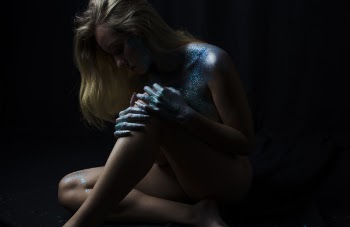 Low Light Photo of Woman With Black Background