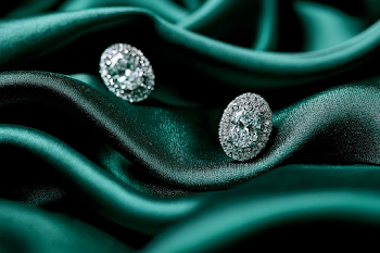 Luxurious Oval Diamond Stud Earrings on Emerald Green Silk