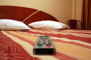 Luxury hotel room decor accommodation with TV remote in front plane