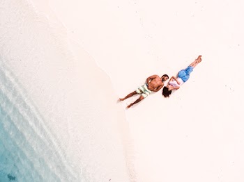 Lying Man and Woman Facing Each Other on Shore