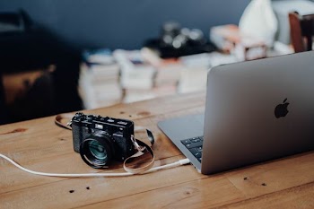 MacBook Air and black SLR camera