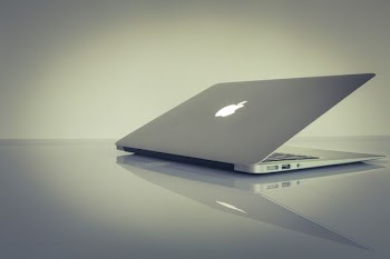 MacBook Air on top of white table