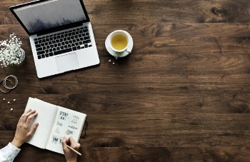 Macbook On Table Beside Teacup