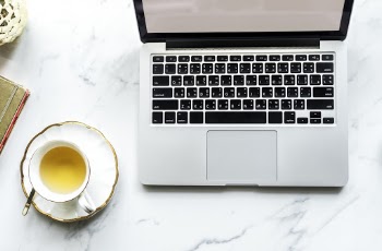 Macbook Pro Beside Teacup