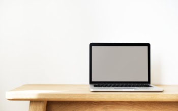 Macbook Pro on Brown Wooden Table