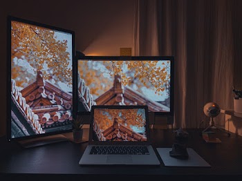 Macbook Pro on Brown Wooden Table