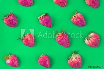 Macro of yummy strawberries on green background
