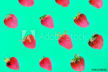 Macro of yummy strawberries on green background