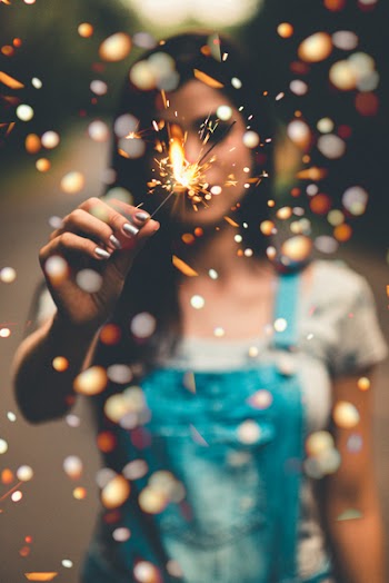 Macro Photo of Woman Holding Fireworks