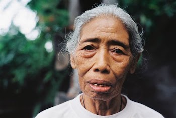 macro photo of woman in white crew-neck top