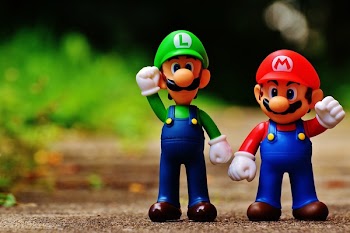 Macro Photography of Mario and Luigi Plastic Toy