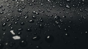 Macro Photography of Rain Drops on Black Surface