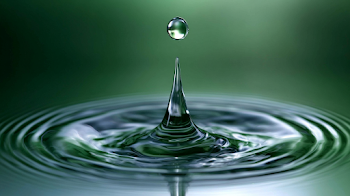 Macro Water Droplet Splash Over Calm Surface