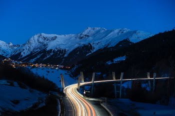 Mainroad to Davos seen from above in the blue hour with light trails