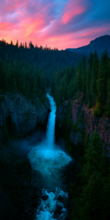 Majestic Waterfall in Lush Canyon at Sunset