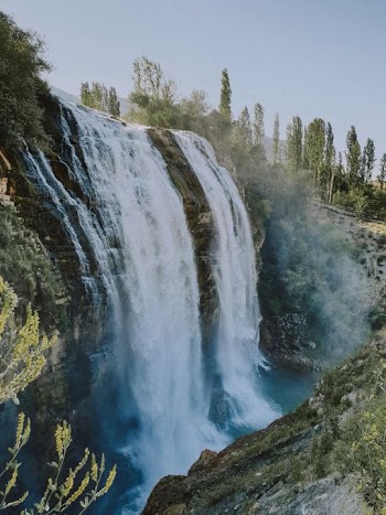 Majestic Waterfall Surrounded by Lush Greenery