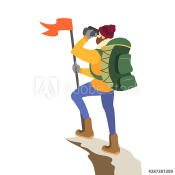 Male alpinist standing on top of the mountain