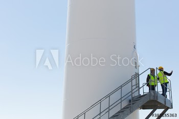 Male engineers on wind turbine staircase