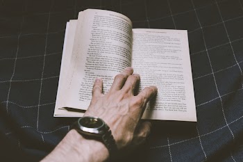 Male hand holding an open book