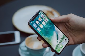 Male holding an iPhone X